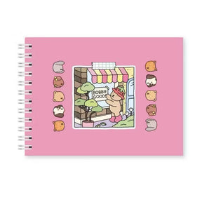 Livro de Colorir Bobbie Goods com ilustrações divertidas e capa em rosa