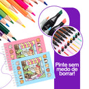 Livro de Colorir Bobbie Goods em capas coloridas com lápis e canetinhas ao redor para pintar livremente