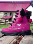 Coturno Infantil Feminino em rosa brilhante com laço preto e pompons, ideal para combinações divertidas