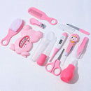 Kit Higiene completo em rosa com acessórios como tesoura, termômetro e escova para cuidados infantis